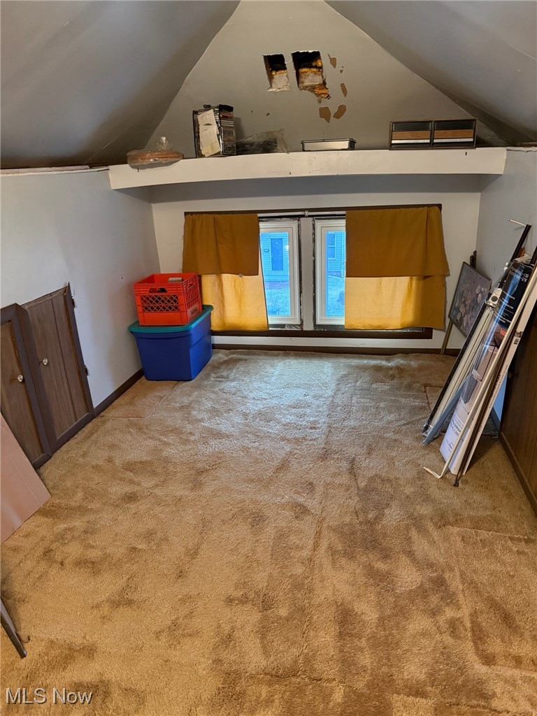 1311 Warner Road Southeast Canton, OH 44707 - Photo 10 of 14 Additional living space with vaulted ceiling and light colored carpet