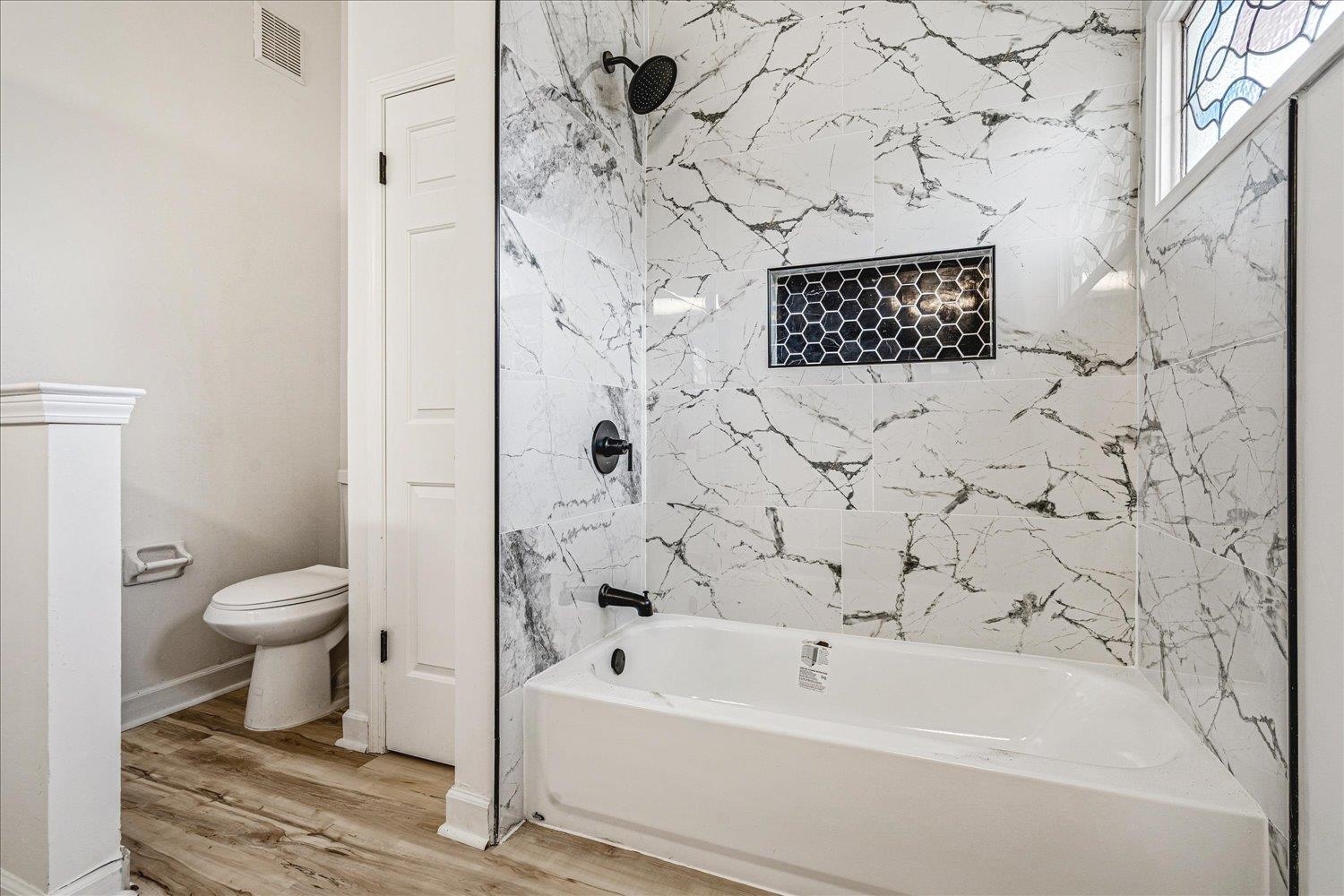 5287 Shady Ridge Drive Memphis, TN 38141 - Photo 12 of 13 Bathroom featuring washtub / shower combination and light wood finished floors
