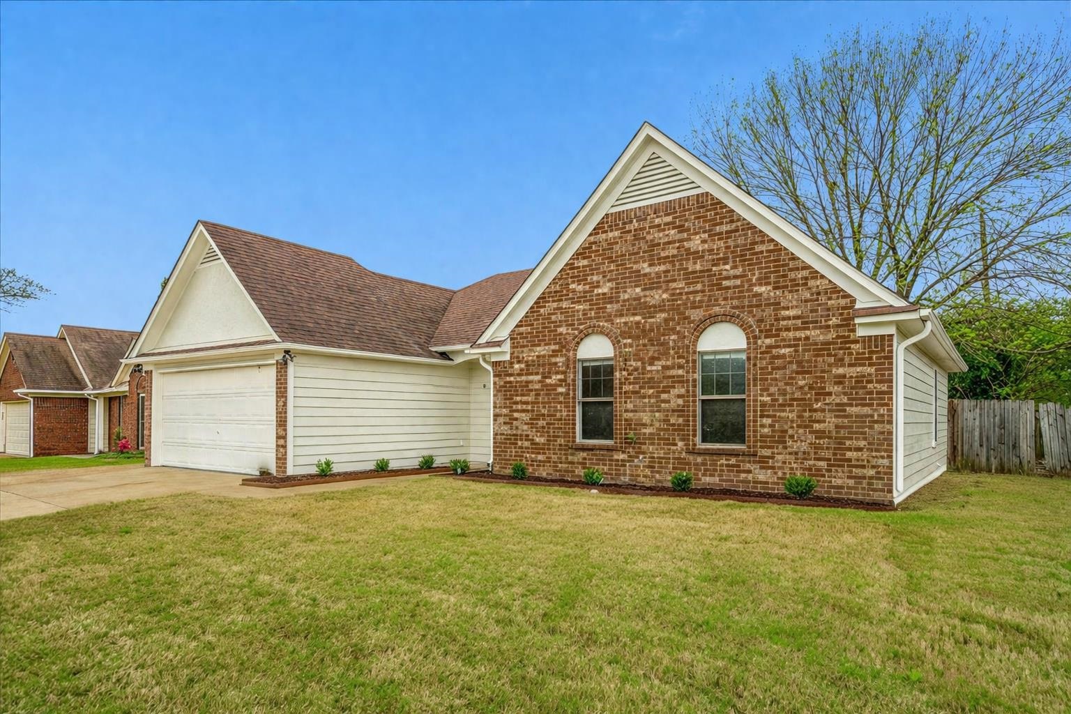 5287 Shady Ridge Drive Memphis, TN 38141 - Photo 2 of 13 Ranch-style home with an attached garage, brick siding, and concrete driveway