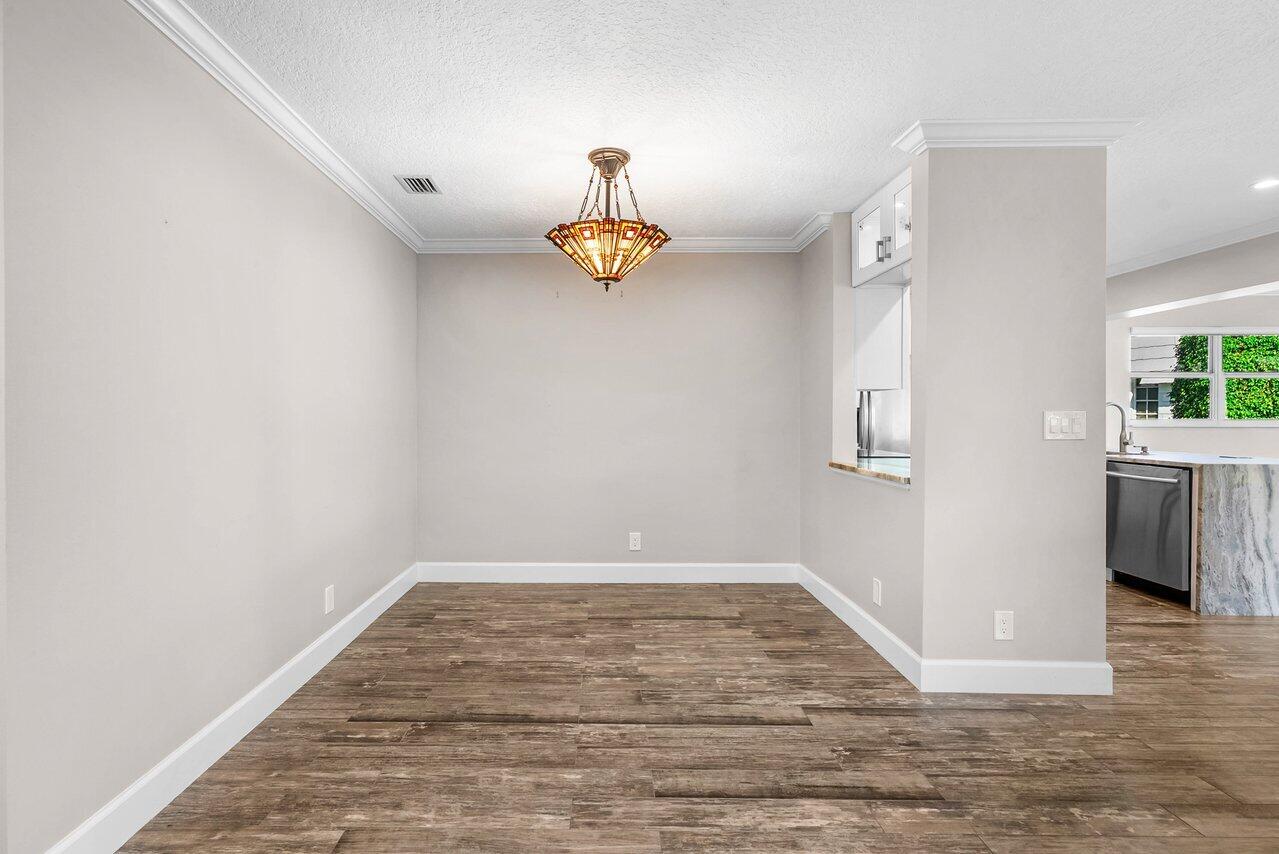 401 French Royale Circle Atlantis, FL 33462 - Photo 11 of 47 a view of empty room with wooden floor