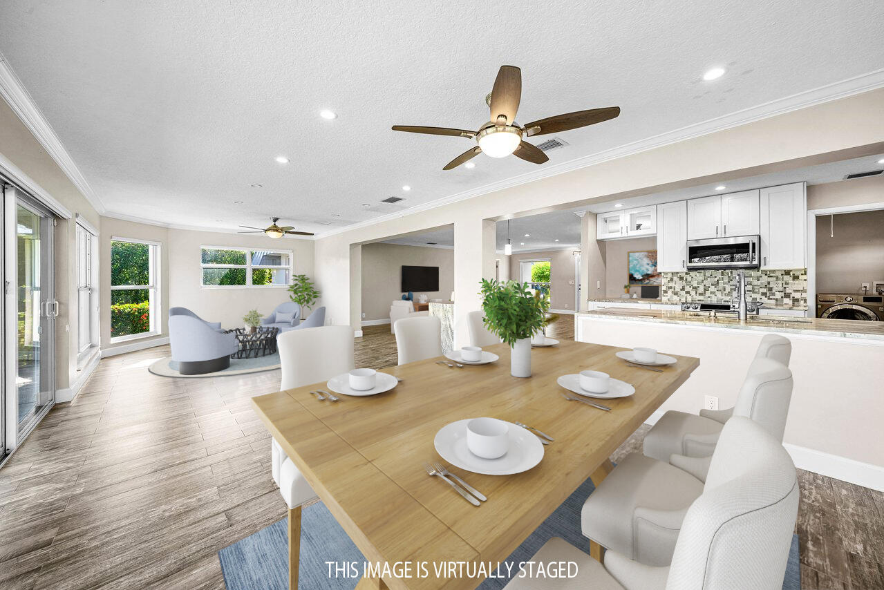 401 French Royale Circle Atlantis, FL 33462 - Photo 20 of 47 a view of a dining room with furniture and wooden floor