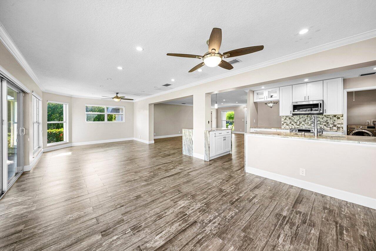 401 French Royale Circle Atlantis, FL 33462 - Photo 21 of 47 a view of a kitchen with wooden floor and window