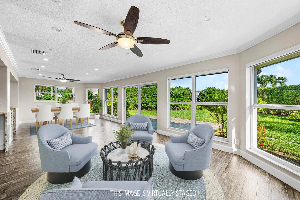 401 French Royale Circle Atlantis, FL 33462 - Photo 22 of 47 a living room with furniture and a large window