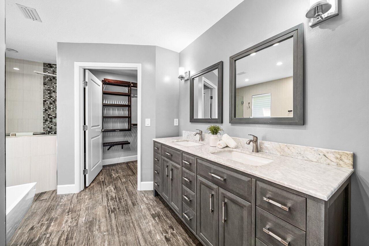 401 French Royale Circle Atlantis, FL 33462 - Photo 26 of 47 a spacious bathroom with a double vanity sink and a mirror
