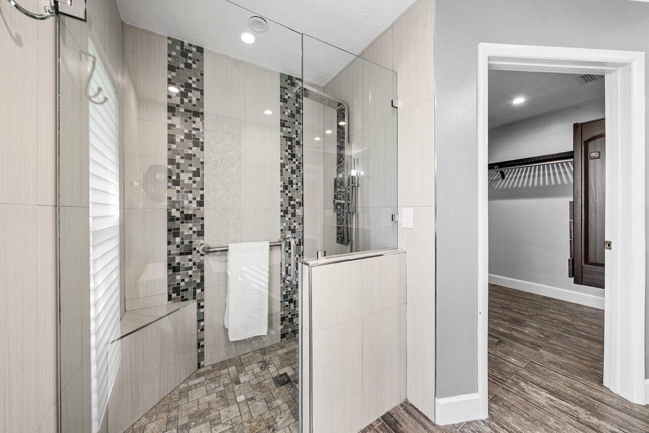 401 French Royale Circle Atlantis, FL 33462 - Photo 27 of 47 a bathroom with a shower and a glass door