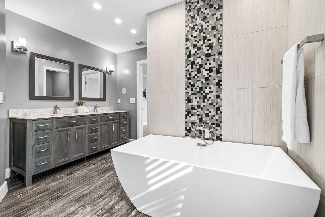 401 French Royale Circle Atlantis, FL 33462 - Photo 28 of 47 a spacious bathroom with a double vanity sink and a mirror