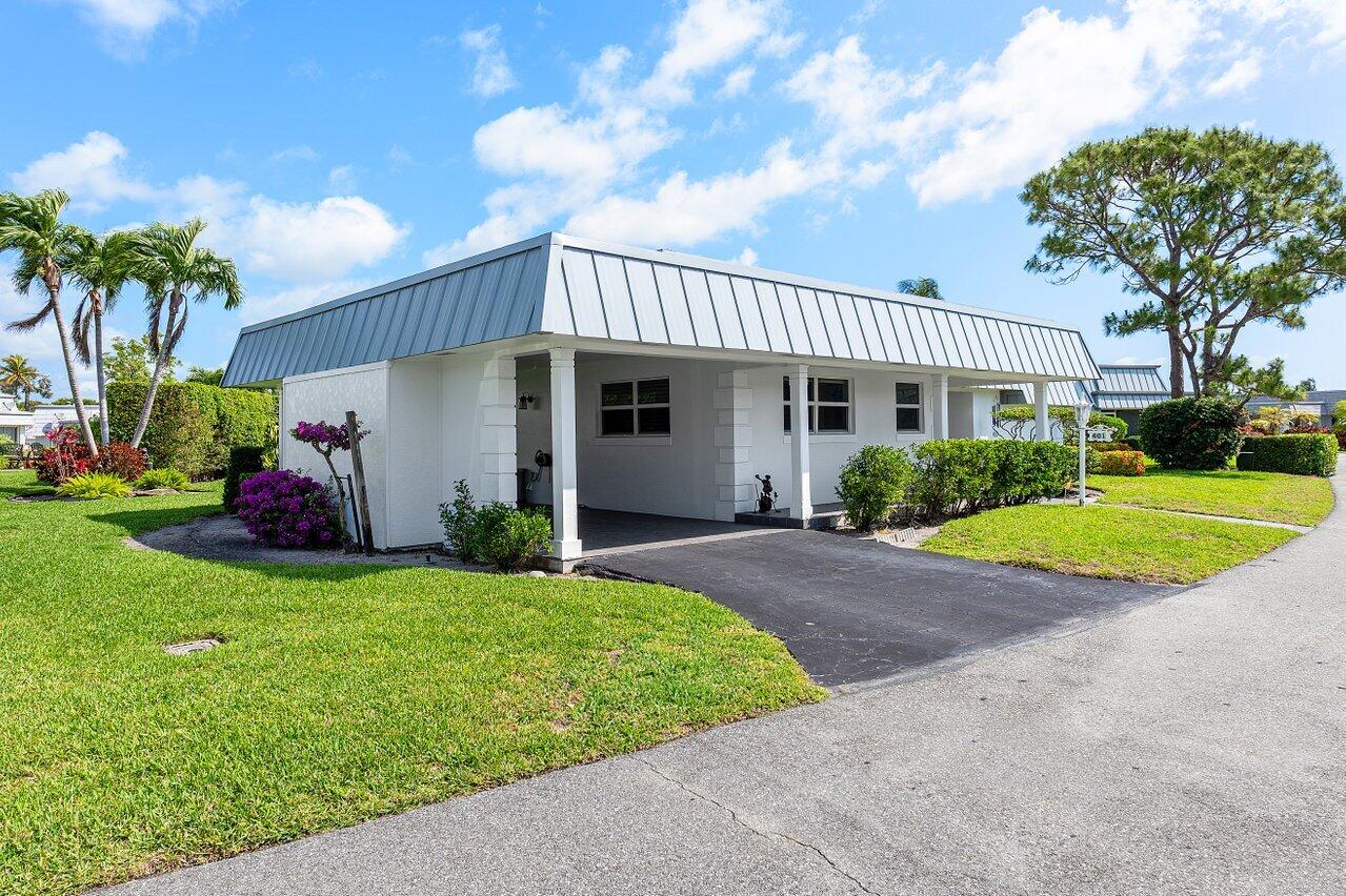 401 French Royale Circle Atlantis, FL 33462 - Photo 3 of 47 a view of a house with backyard and a tree