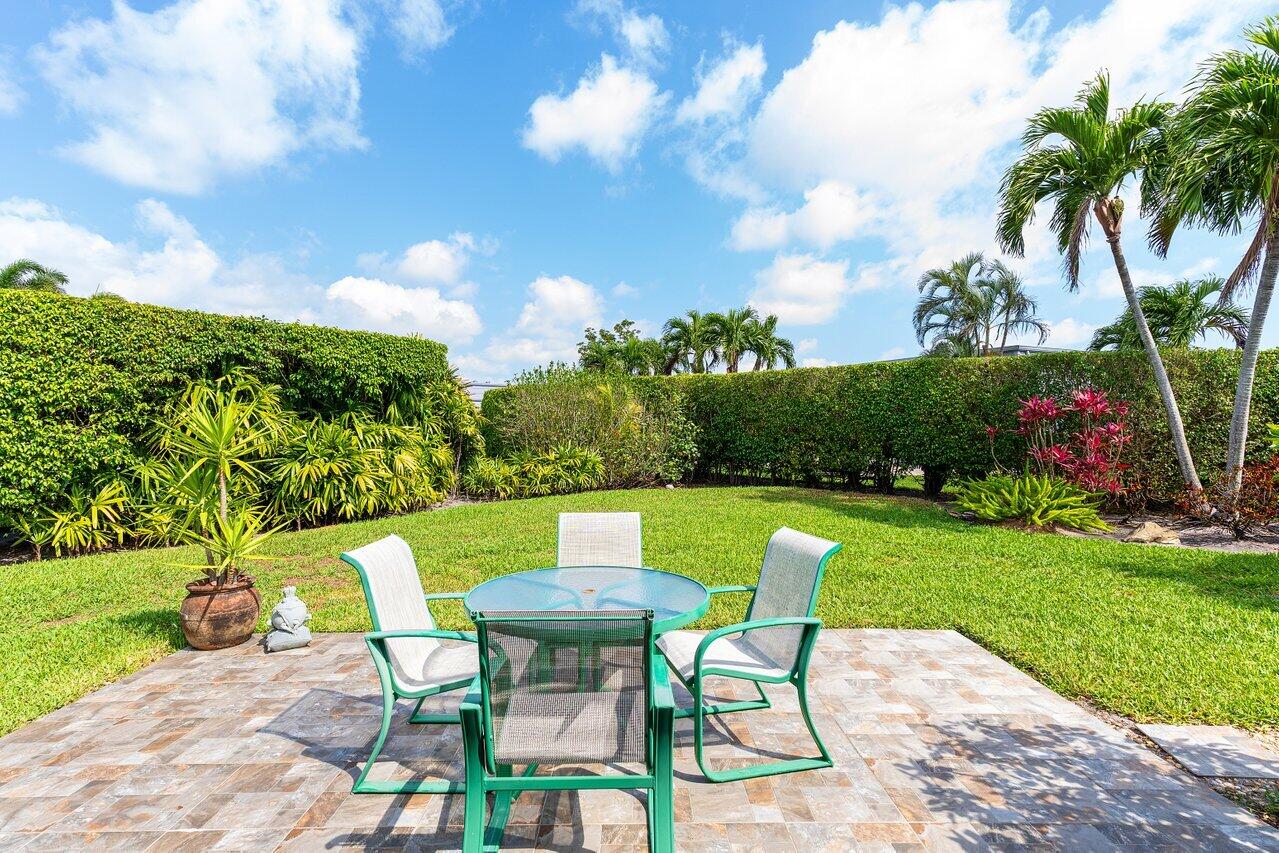 401 French Royale Circle Atlantis, FL 33462 - Photo 35 of 47 a view of a chairs and table in patio