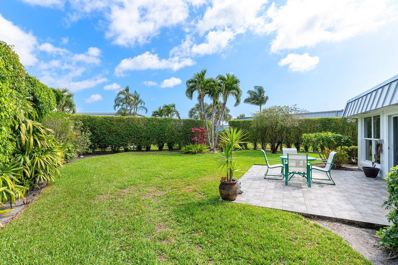 401 French Royale Circle Atlantis, FL 33462 - Photo 38 of 47 a view of a garden with sitting area