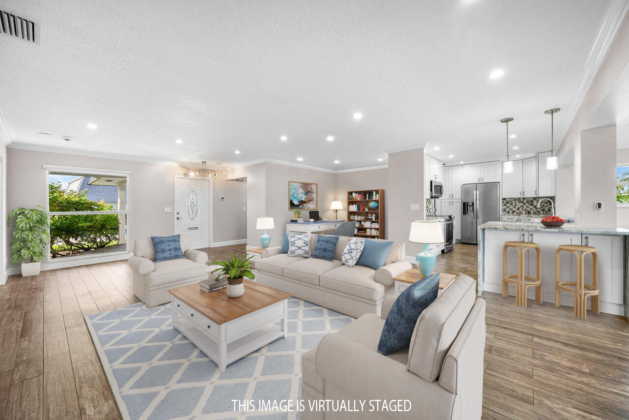 401 French Royale Circle Atlantis, FL 33462 - Photo 6 of 47 a living room with furniture and a large window