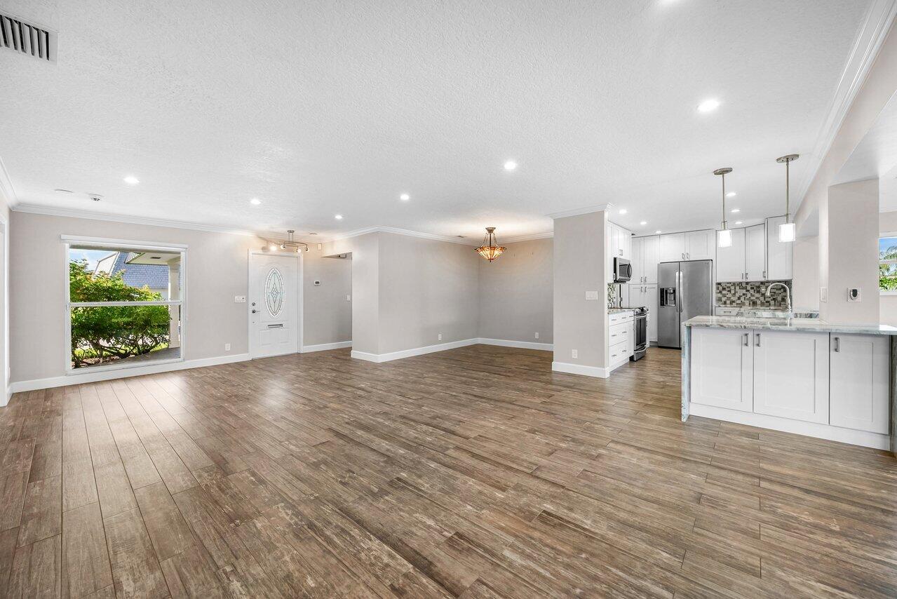 401 French Royale Circle Atlantis, FL 33462 - Photo 7 of 47 a view of kitchen with kitchen island large window and refrigerator