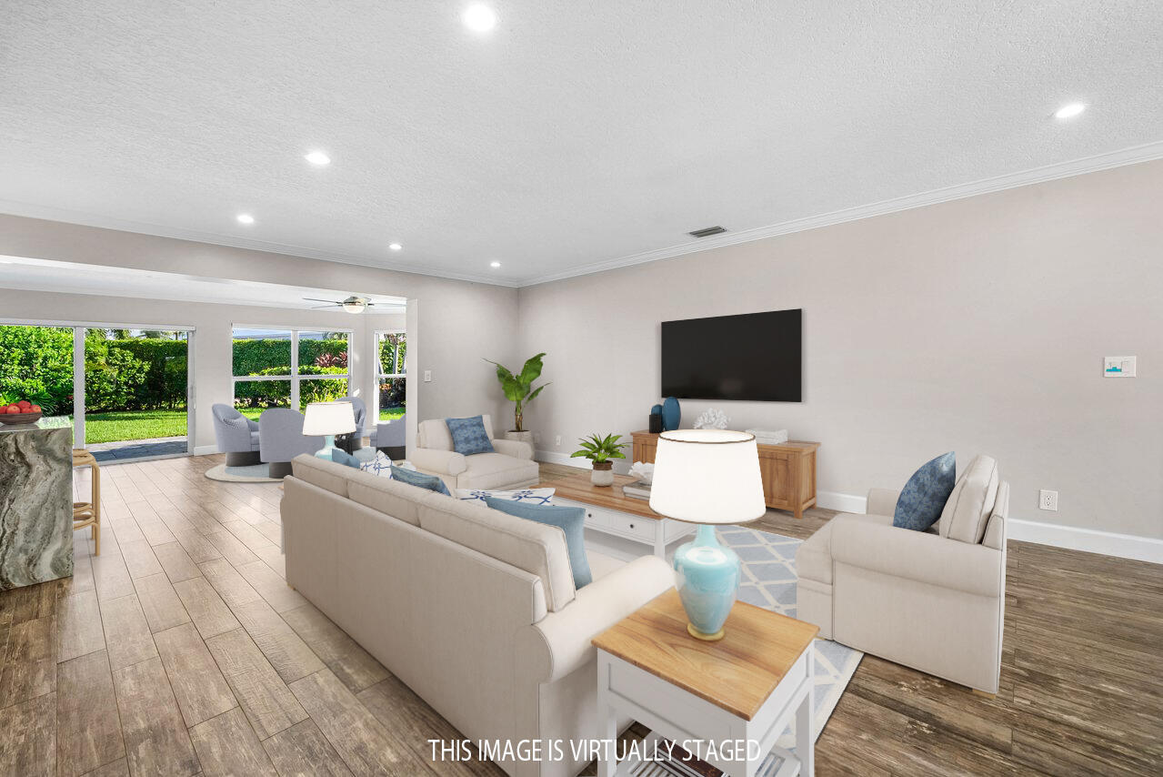 401 French Royale Circle Atlantis, FL 33462 - Photo 8 of 47 a living room with furniture and a flat screen tv