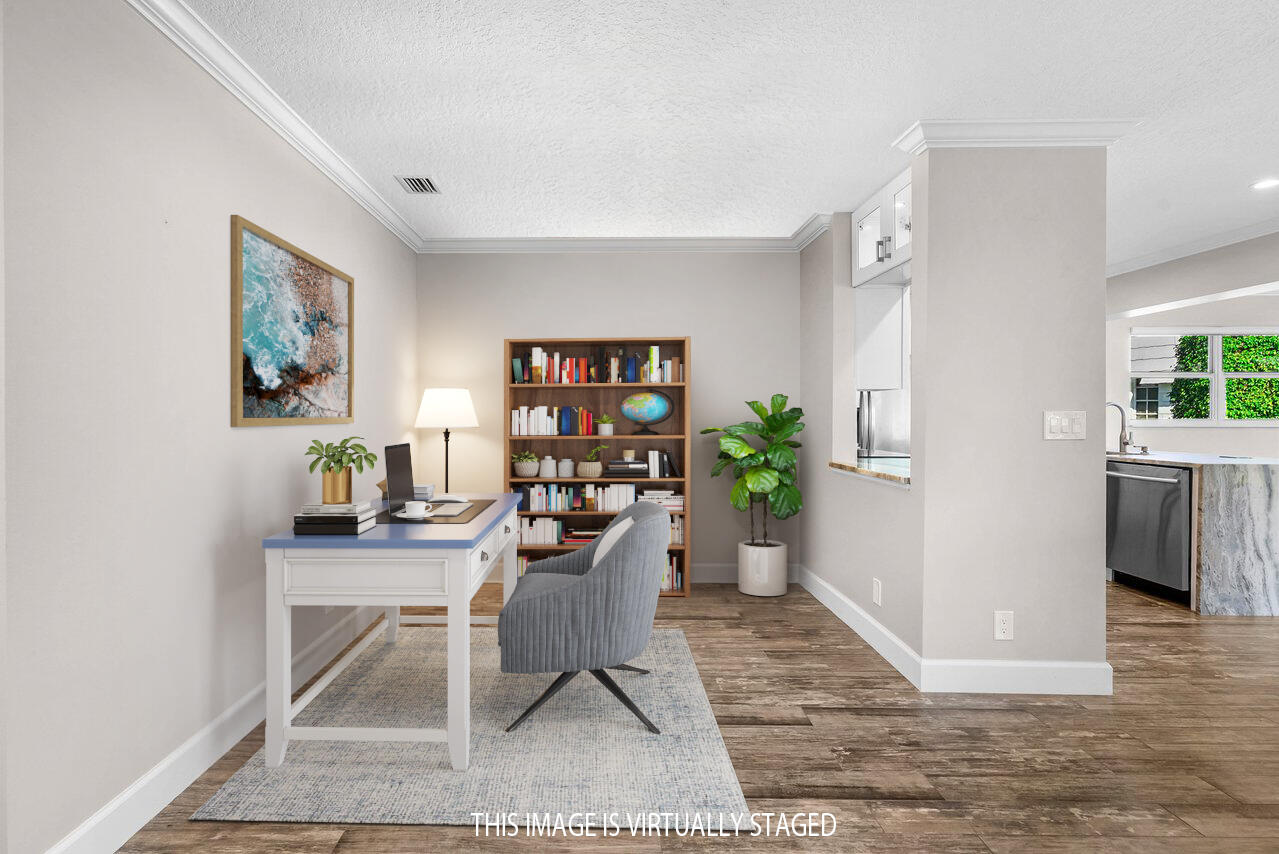 401 French Royale Circle Atlantis, FL 33462 - Photo 10 of 47 a view of a workspace with furniture and a potted plant