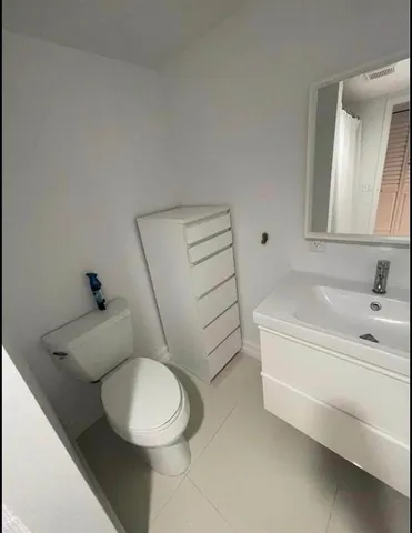 a bathroom with a sink a toilet and bathtub