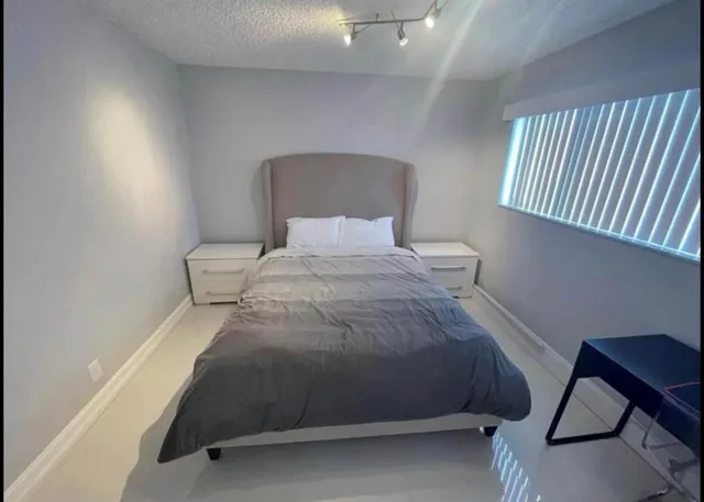 a bedroom with a bed and a chair