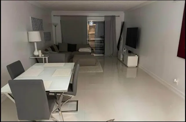 a living room with furniture a desk and chair