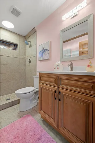 a view of a swimming pool with a yard and a large tree