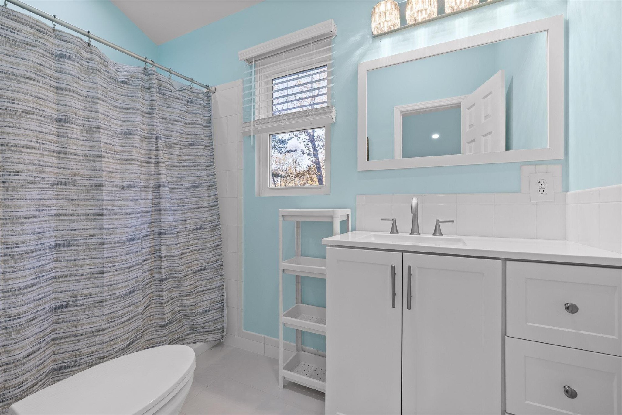 504 Wolf Run Rising Fawn, GA 30738 - Photo 69 of 100 a bathroom with a toilet sink vanity and mirror