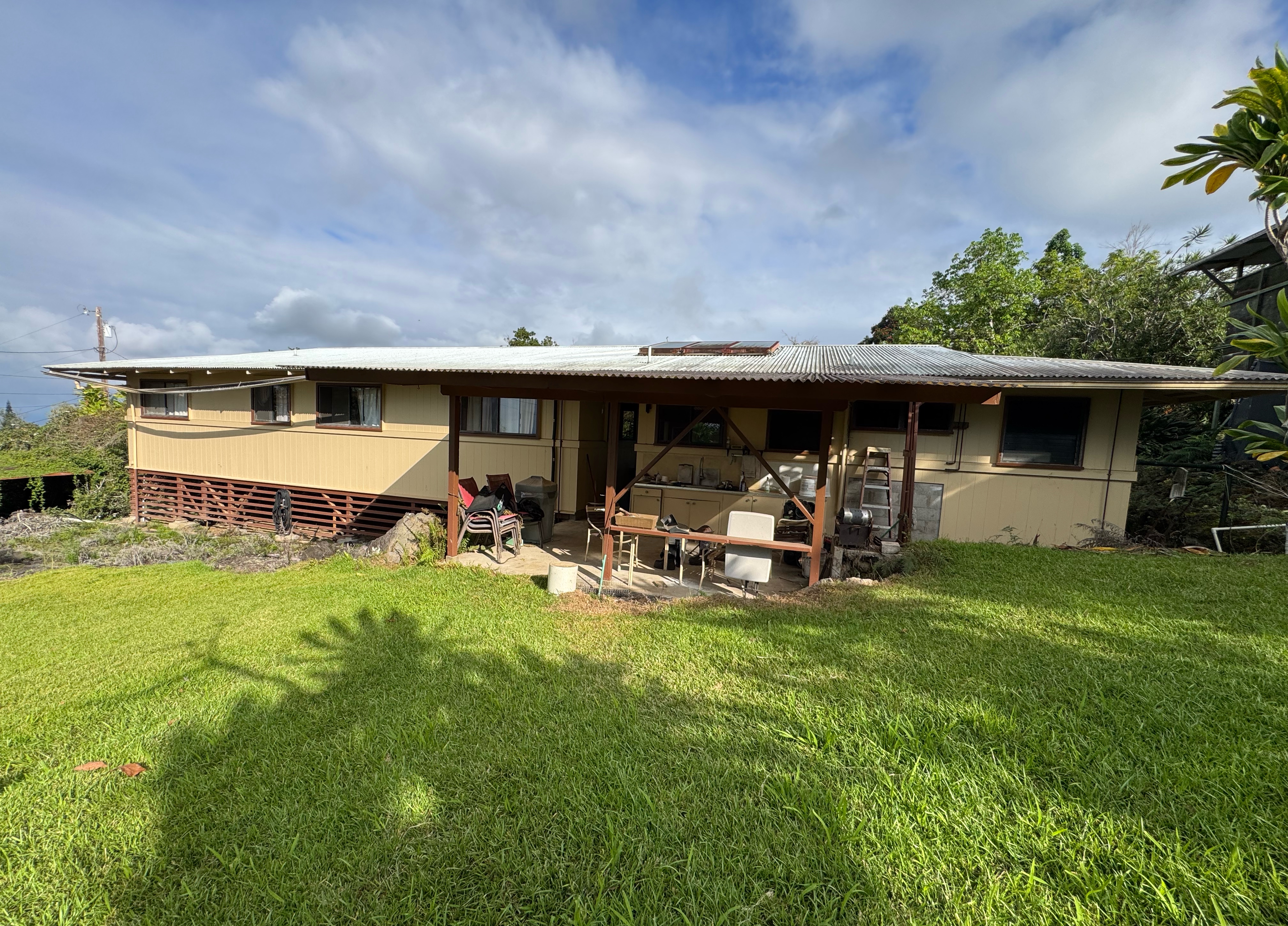 a view of a house with backyard porch and sitting area