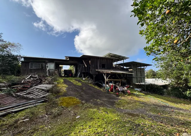 a view of a patio with table and chairs under an umbrella