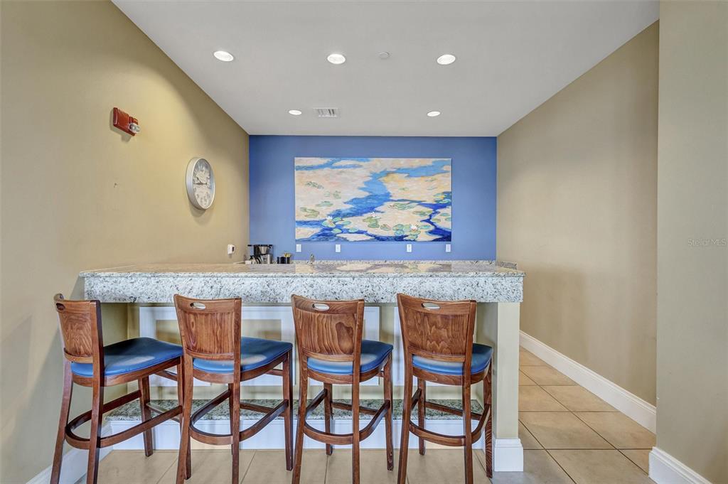 140 Riviera Dunes Way, Unit 206 Palmetto, FL 34221 - Photo 26 of 46 a view of a dining table and chairs in a room