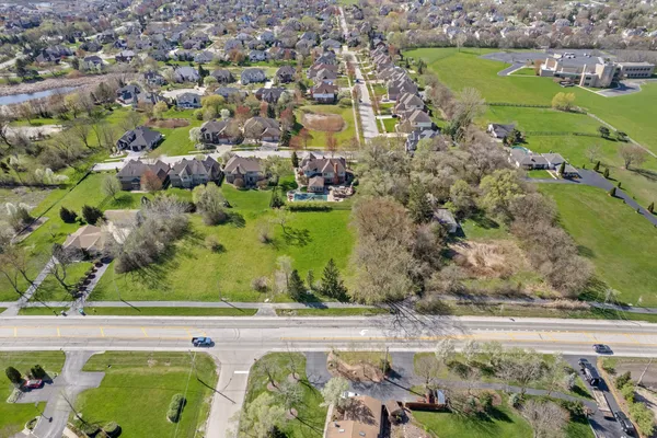 an aerial view of residential houses with outdoor space and seating