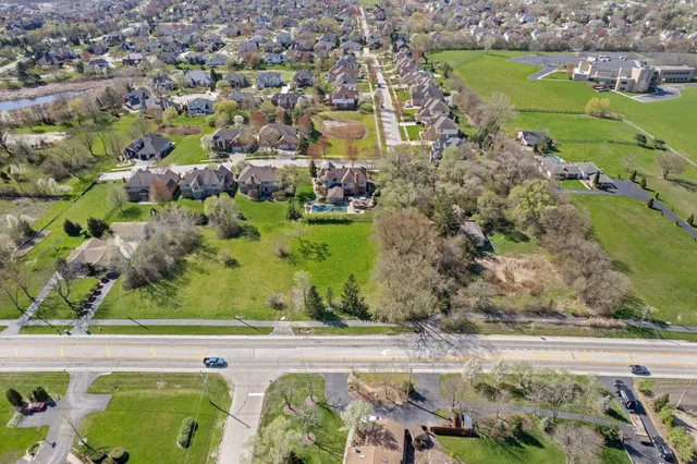 an aerial view of residential houses with outdoor space and seating