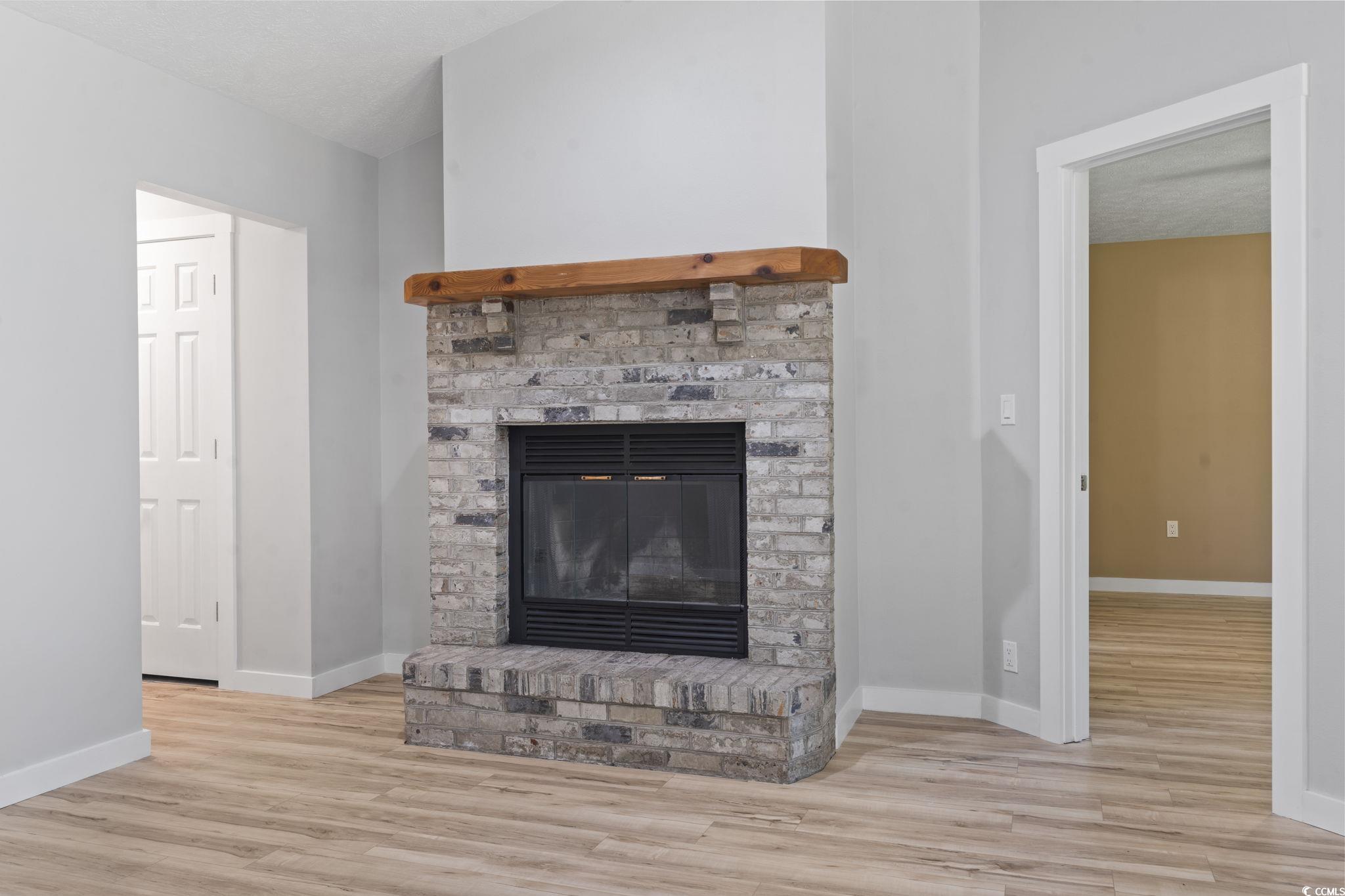 220 Rice Mill Drive Myrtle Beach, SC 29588 - Photo 14 of 31 Detailed view of wood finished floors and a brick fireplace