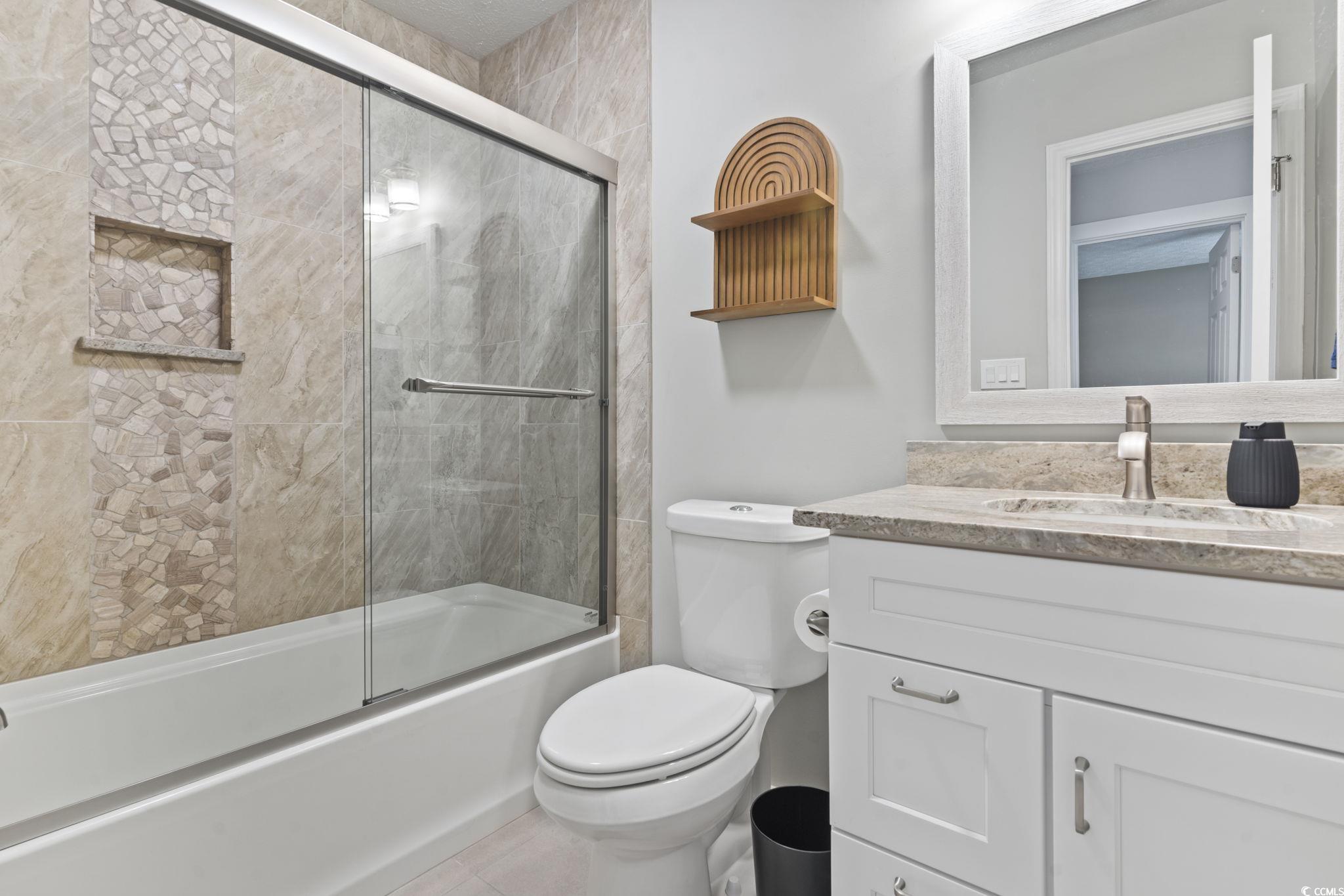 220 Rice Mill Drive Myrtle Beach, SC 29588 - Photo 20 of 31 Full bathroom with vanity and bath / shower combo with glass door