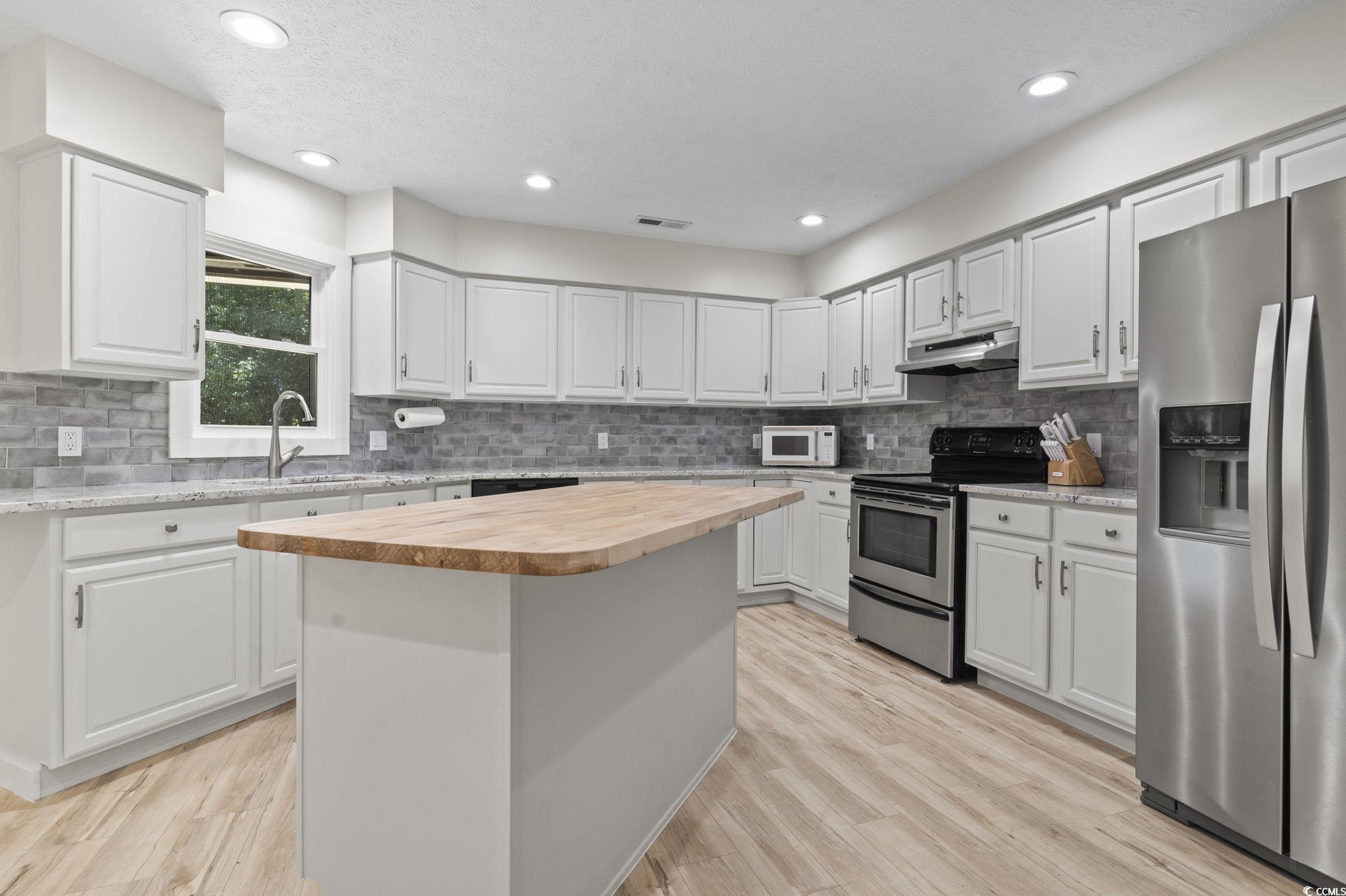 220 Rice Mill Drive Myrtle Beach, SC 29588 - Photo 6 of 31 Kitchen featuring wood counters, stainless steel appliances, backsplash, a kitchen island, and recessed lighting