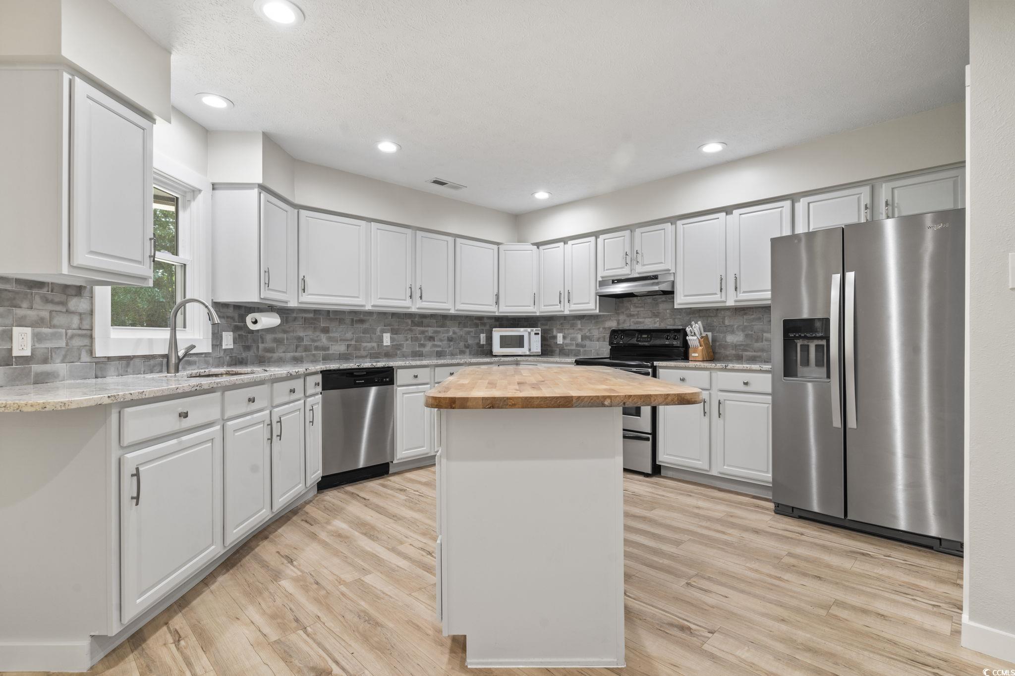 220 Rice Mill Drive Myrtle Beach, SC 29588 - Photo 9 of 31 Kitchen featuring wood counters, stainless steel appliances, a center island, backsplash, and recessed lighting