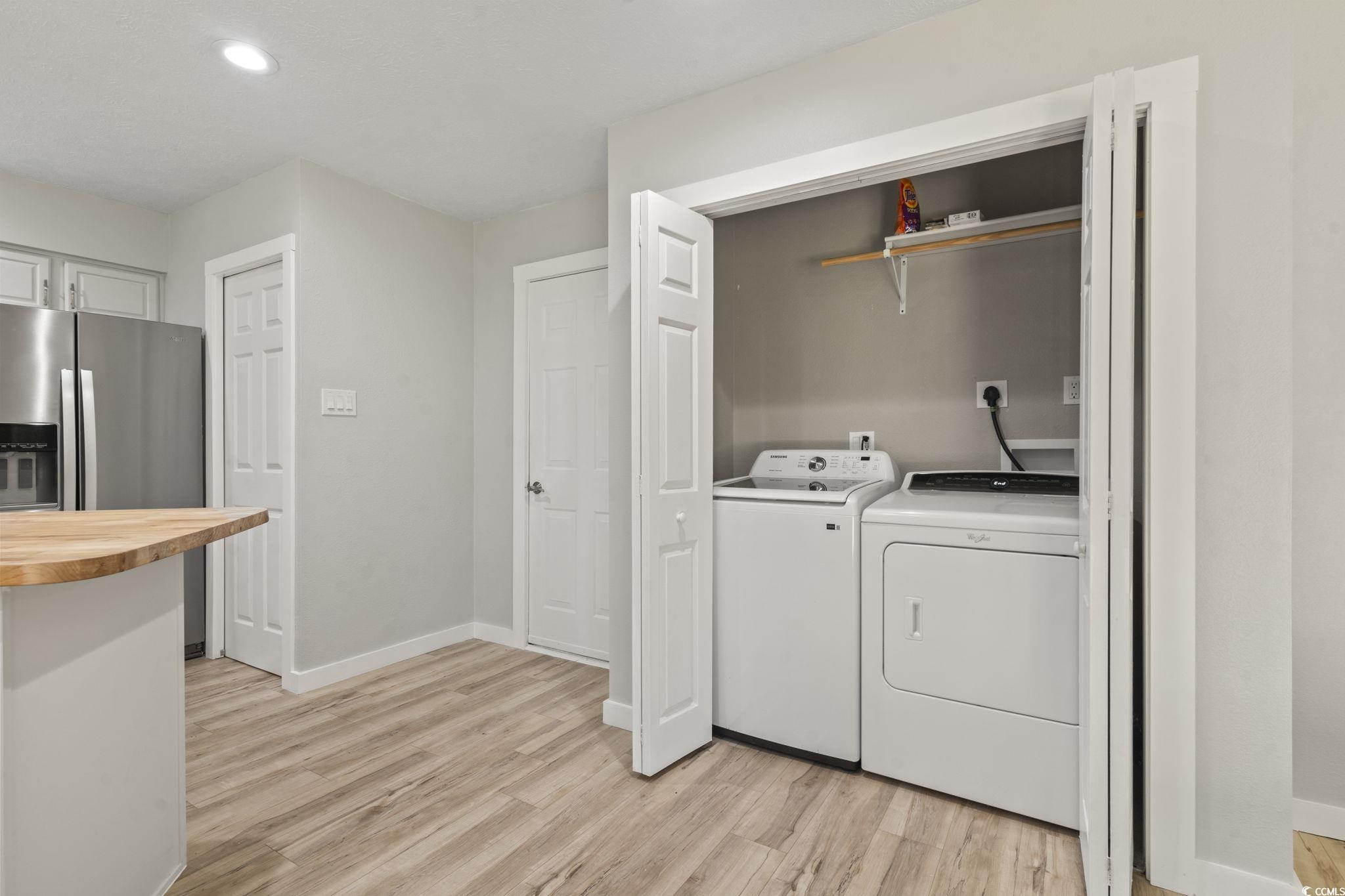 220 Rice Mill Drive Myrtle Beach, SC 29588 - Photo 10 of 31 Washroom with washing machine and clothes dryer, light wood-style flooring, and recessed lighting