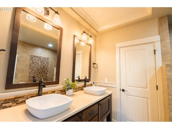 a bathroom with a double vanity sink and a mirror