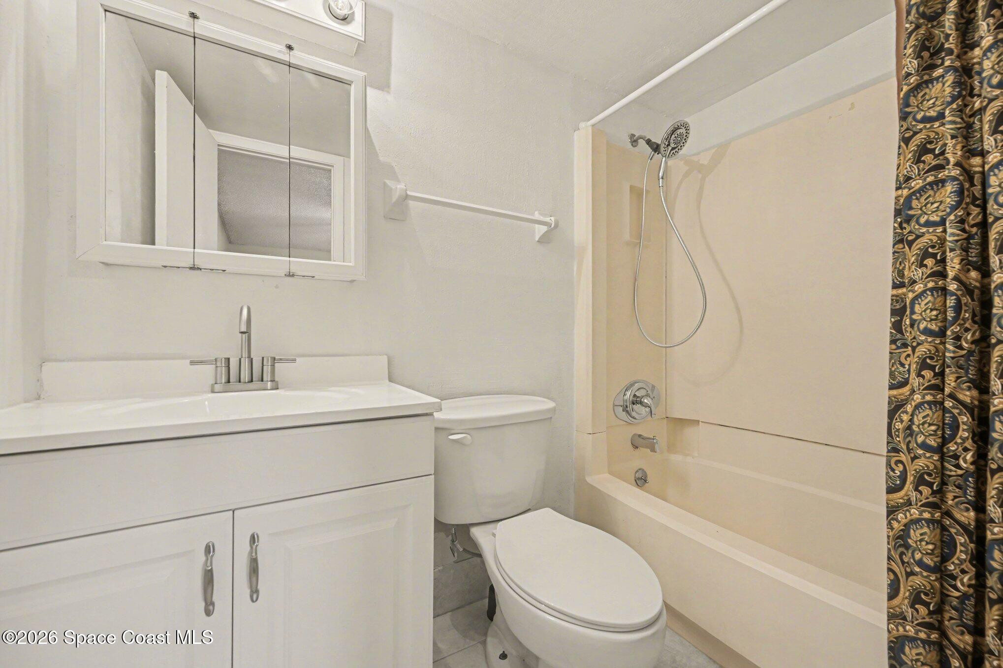 101 Bristol Lane, Unit 101 Melbourne, FL 32935 - Photo 13 of 16 a bathroom with a sink toilet and shower