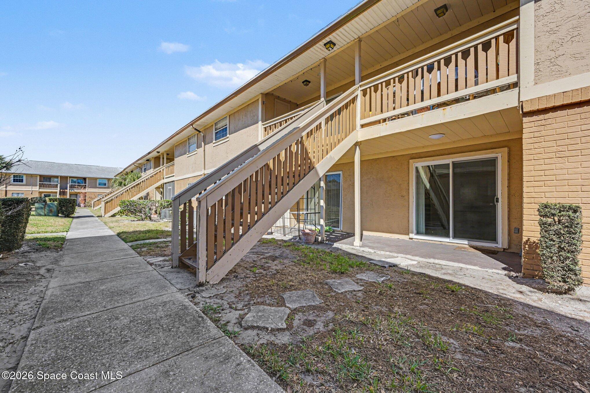 101 Bristol Lane, Unit 101 Melbourne, FL 32935 - Photo 14 of 16 a view of building with stairs