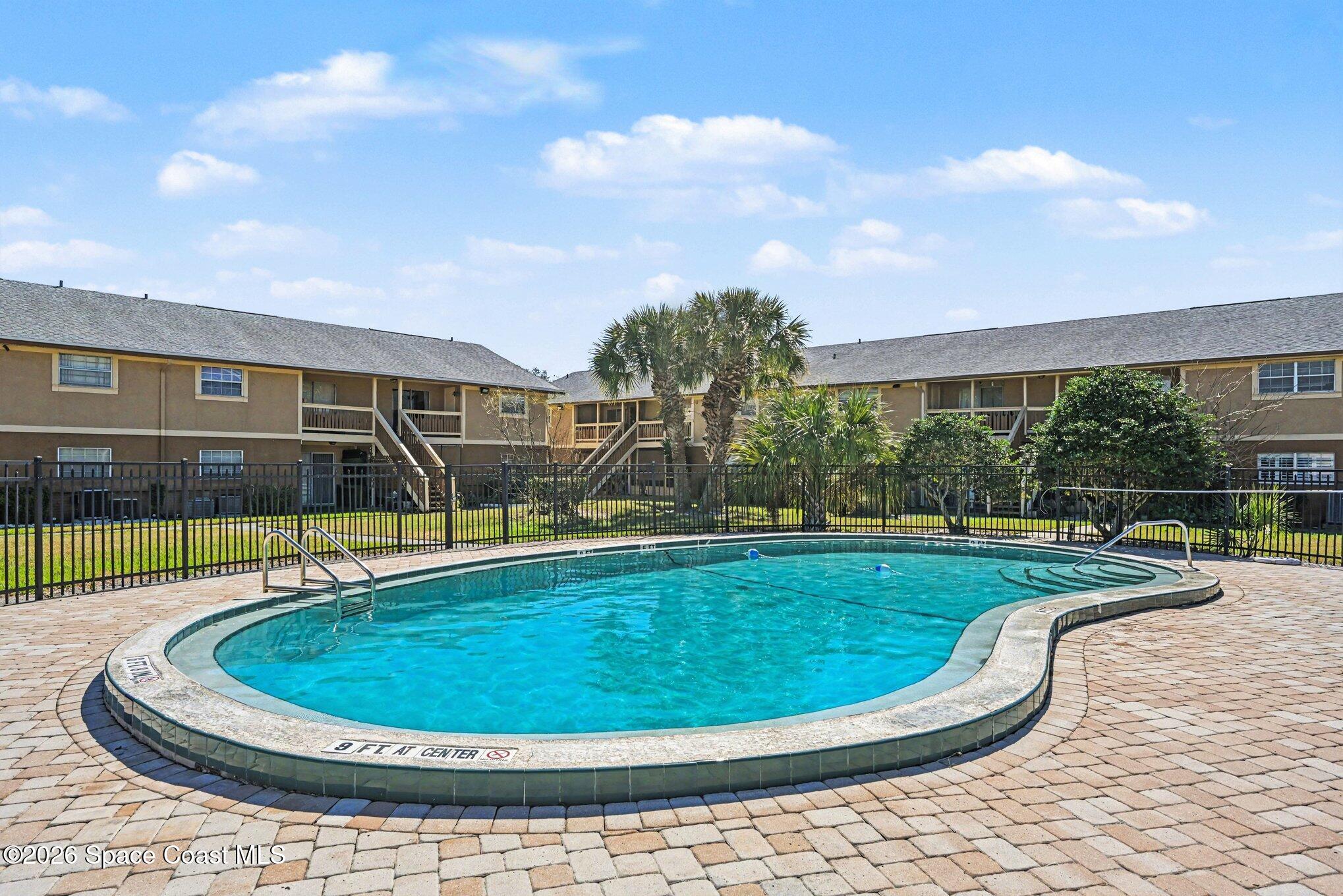 101 Bristol Lane, Unit 101 Melbourne, FL 32935 - Photo 16 of 16 a view of a swimming pool with a garden