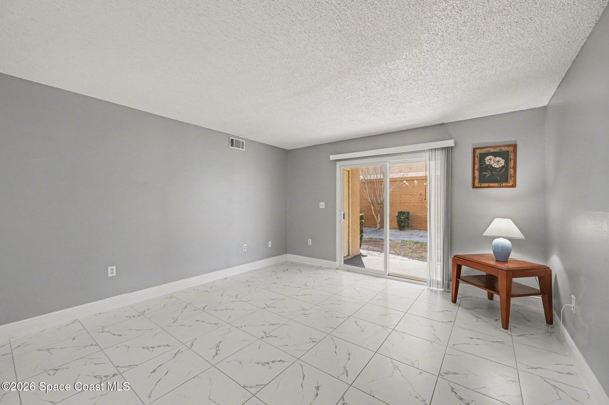 101 Bristol Lane, Unit 101 Melbourne, FL 32935 - Photo 2 of 16 a view of room with workspace and windows