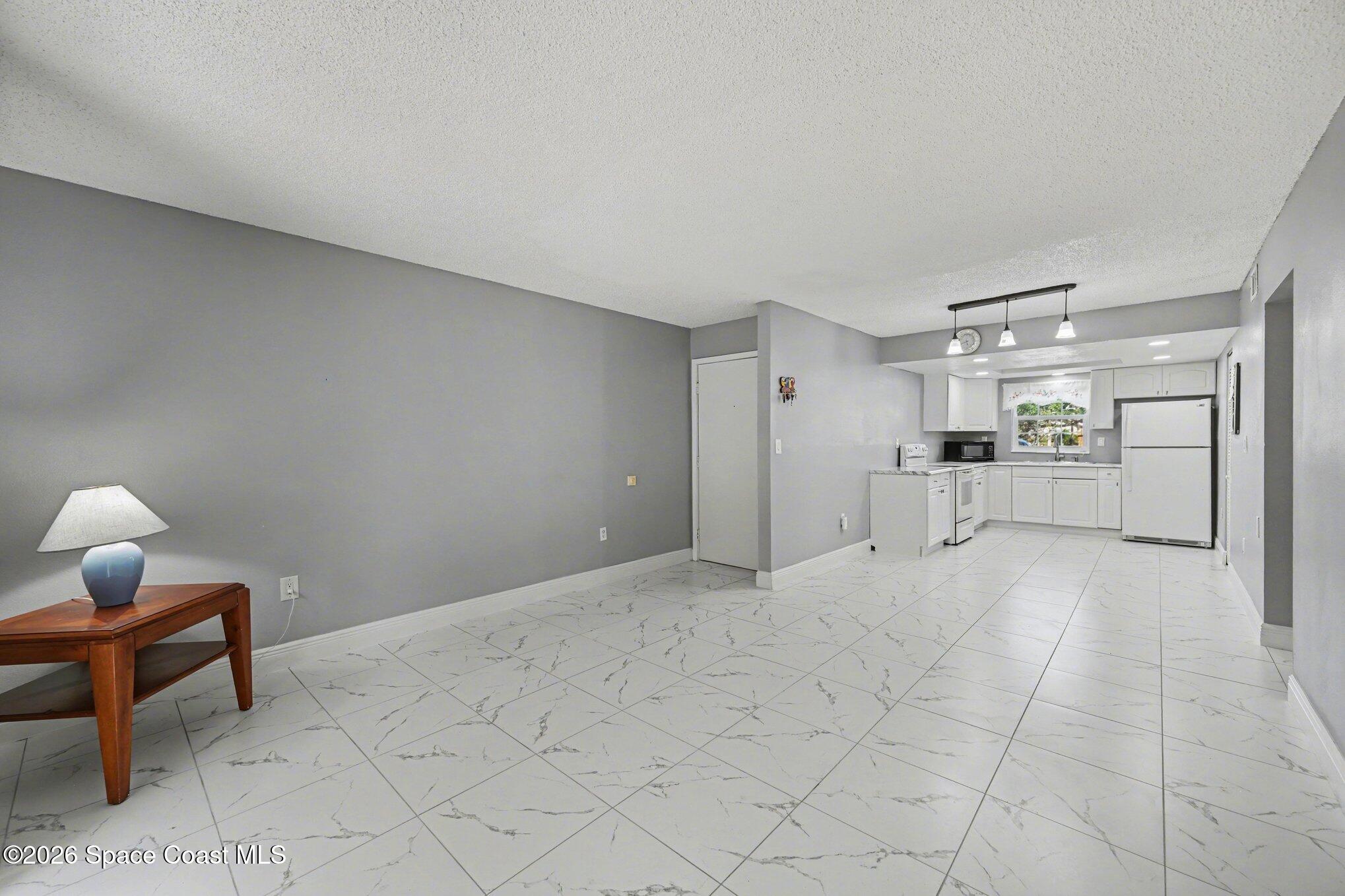 101 Bristol Lane, Unit 101 Melbourne, FL 32935 - Photo 5 of 16 a view of empty room with wooden floor