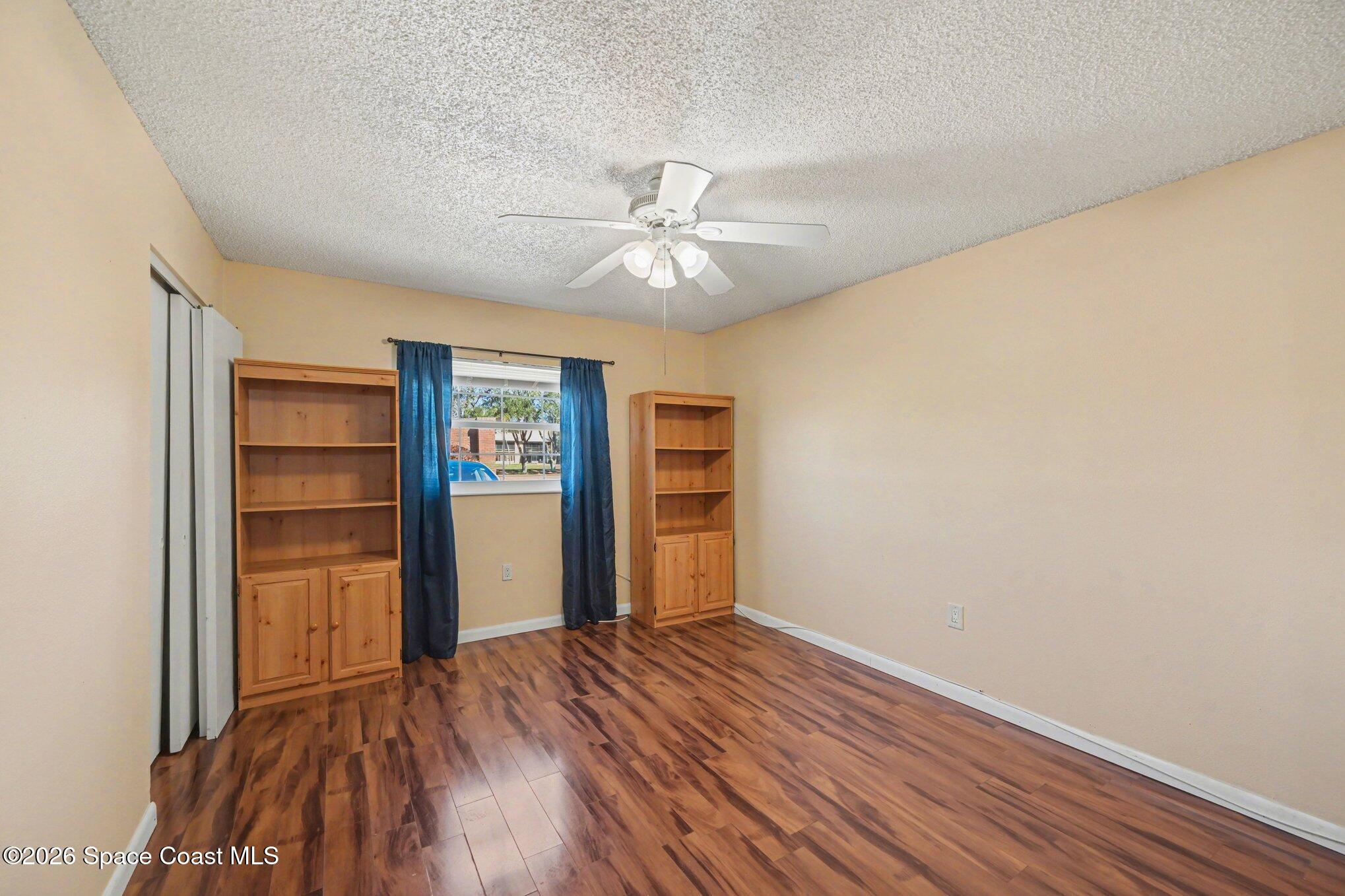 101 Bristol Lane, Unit 101 Melbourne, FL 32935 - Photo 8 of 16 wooden floor in an empty room with a window
