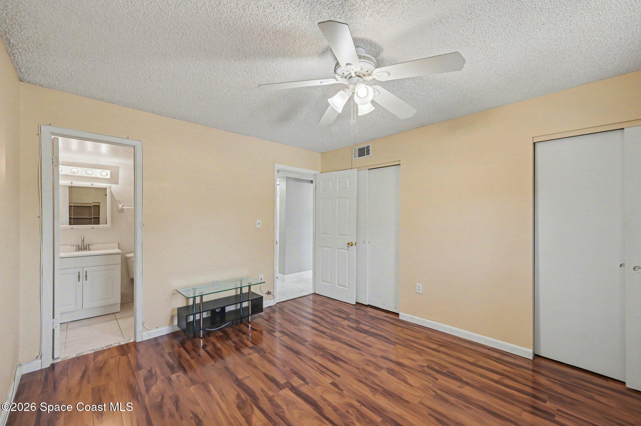101 Bristol Lane, Unit 101 Melbourne, FL 32935 - Photo 9 of 16 a view of empty room with wooden floor and fan