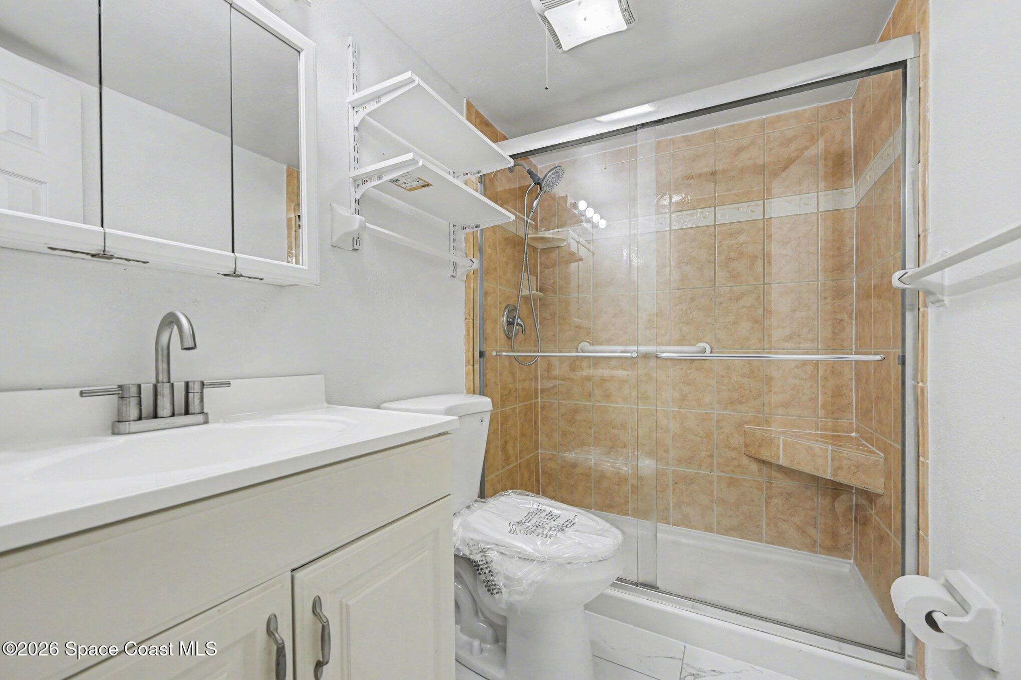 101 Bristol Lane, Unit 101 Melbourne, FL 32935 - Photo 10 of 16 a bathroom with a sink toilet and shower