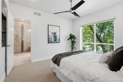 a bedroom with a large bed and a large window