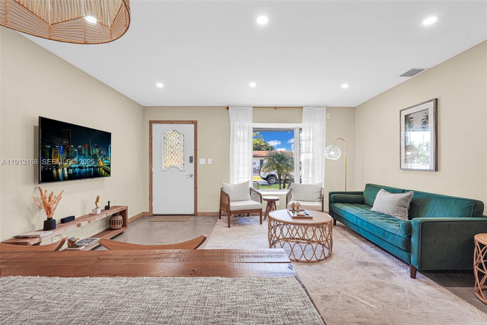 1012 Northeast 2nd Street Hallandale Beach, FL 33009 - Photo 12 of 65 a living room with furniture and a flat screen tv
