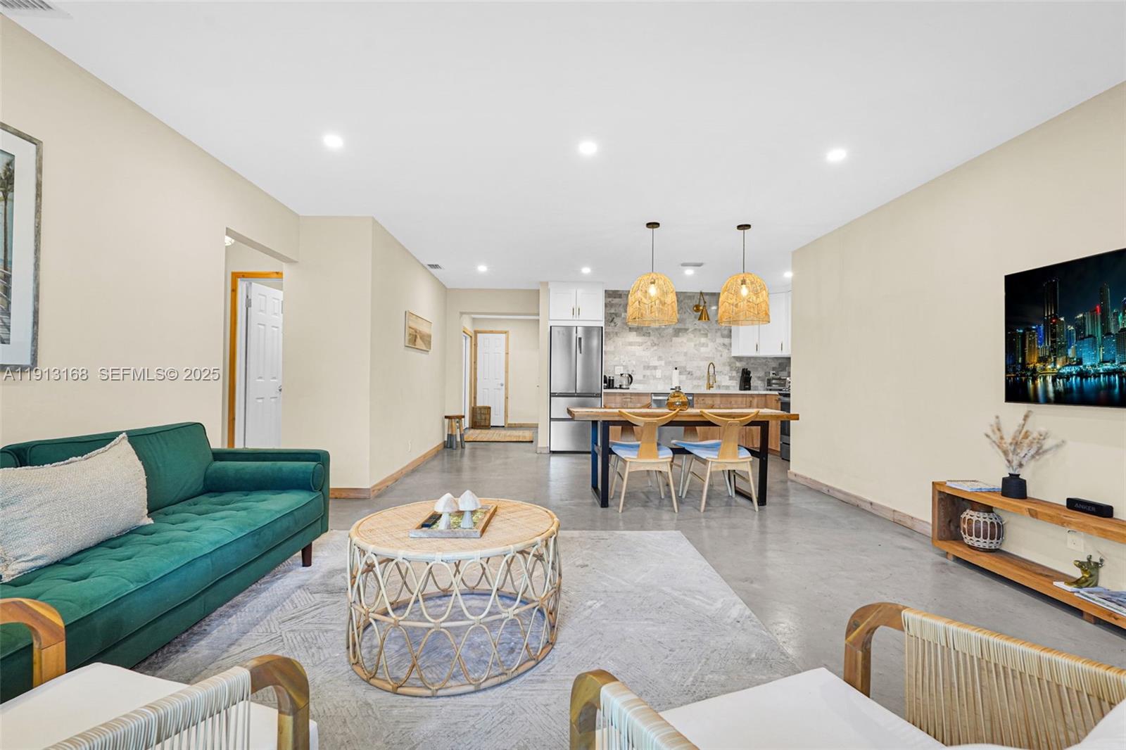 1012 Northeast 2nd Street Hallandale Beach, FL 33009 - Photo 13 of 65 a living room with furniture and a flat screen tv