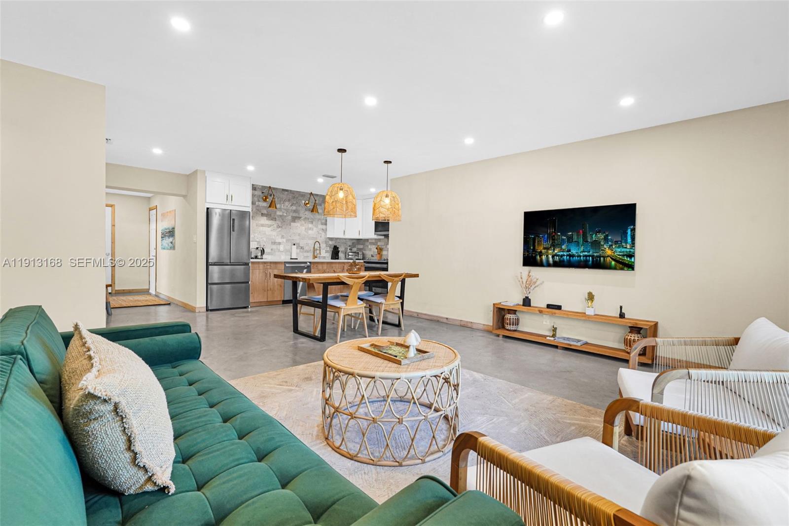 1012 Northeast 2nd Street Hallandale Beach, FL 33009 - Photo 15 of 65 a living room with furniture and a flat screen tv