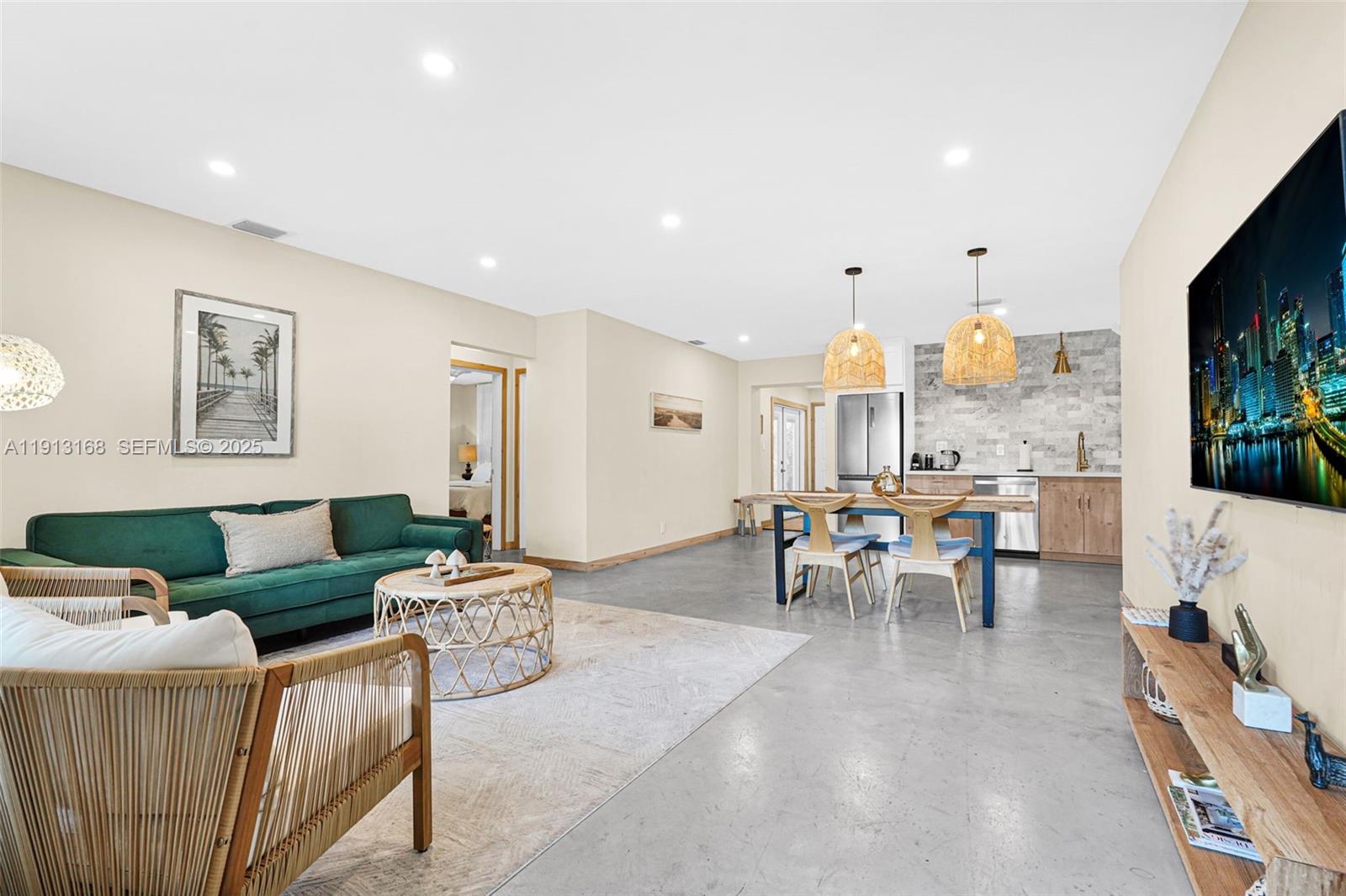 1012 Northeast 2nd Street Hallandale Beach, FL 33009 - Photo 16 of 65 a living room with furniture and a flat screen tv
