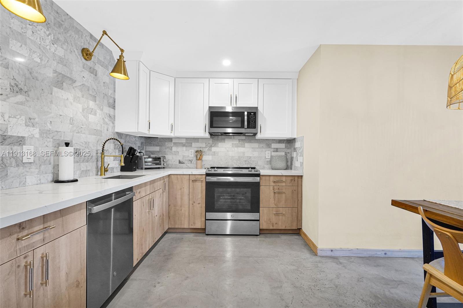 1012 Northeast 2nd Street Hallandale Beach, FL 33009 - Photo 18 of 65 a kitchen with a sink and a stove top oven