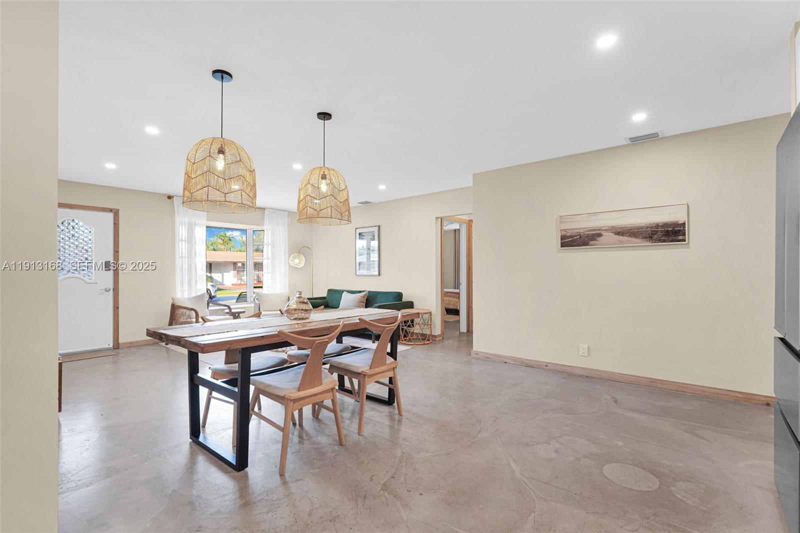 1012 Northeast 2nd Street Hallandale Beach, FL 33009 - Photo 20 of 65 a view of a dining room and livingroom with furniture window and wooden floor