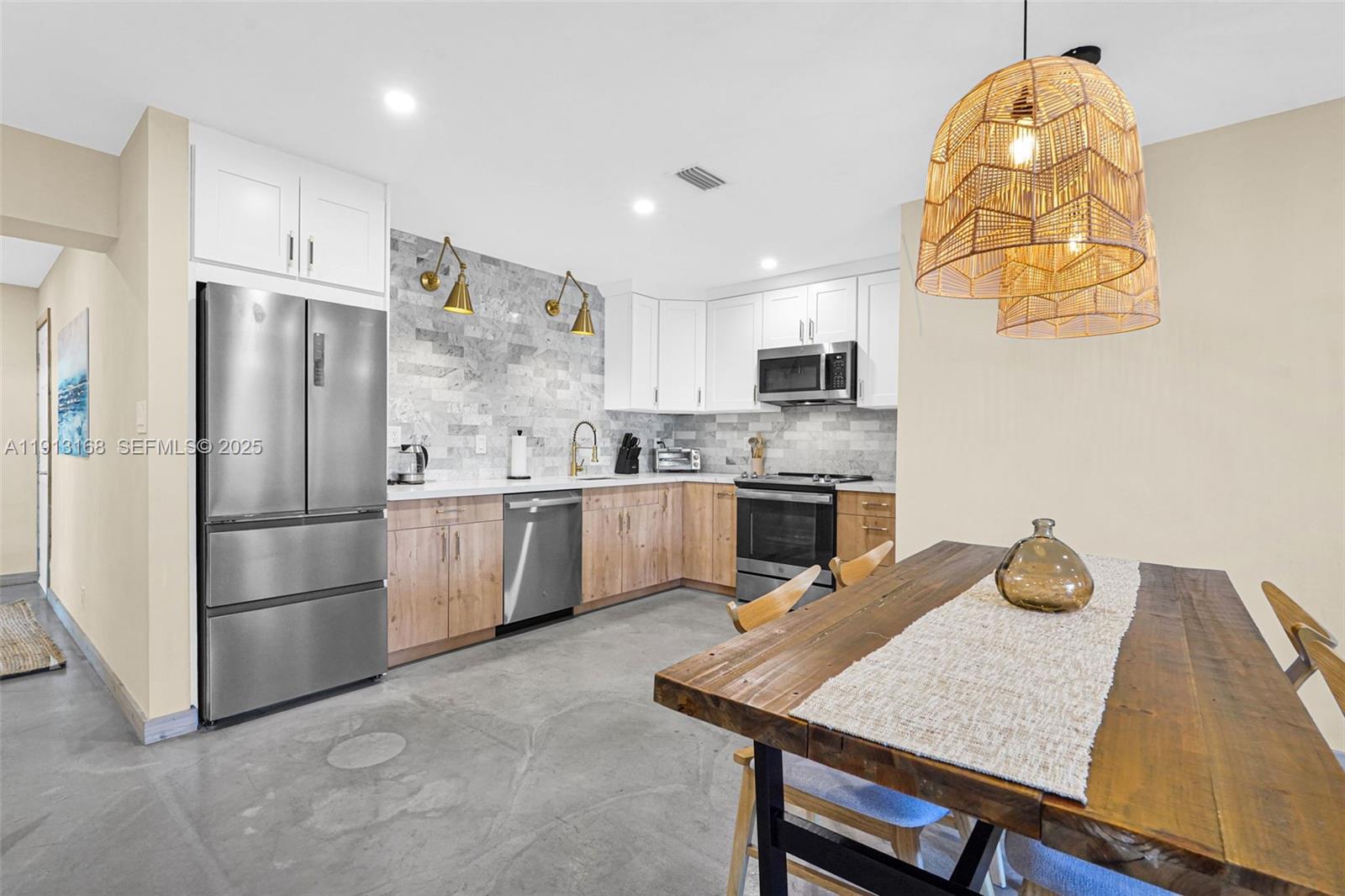 1012 Northeast 2nd Street Hallandale Beach, FL 33009 - Photo 22 of 65 a kitchen with stainless steel appliances granite countertop a sink refrigerator and microwave