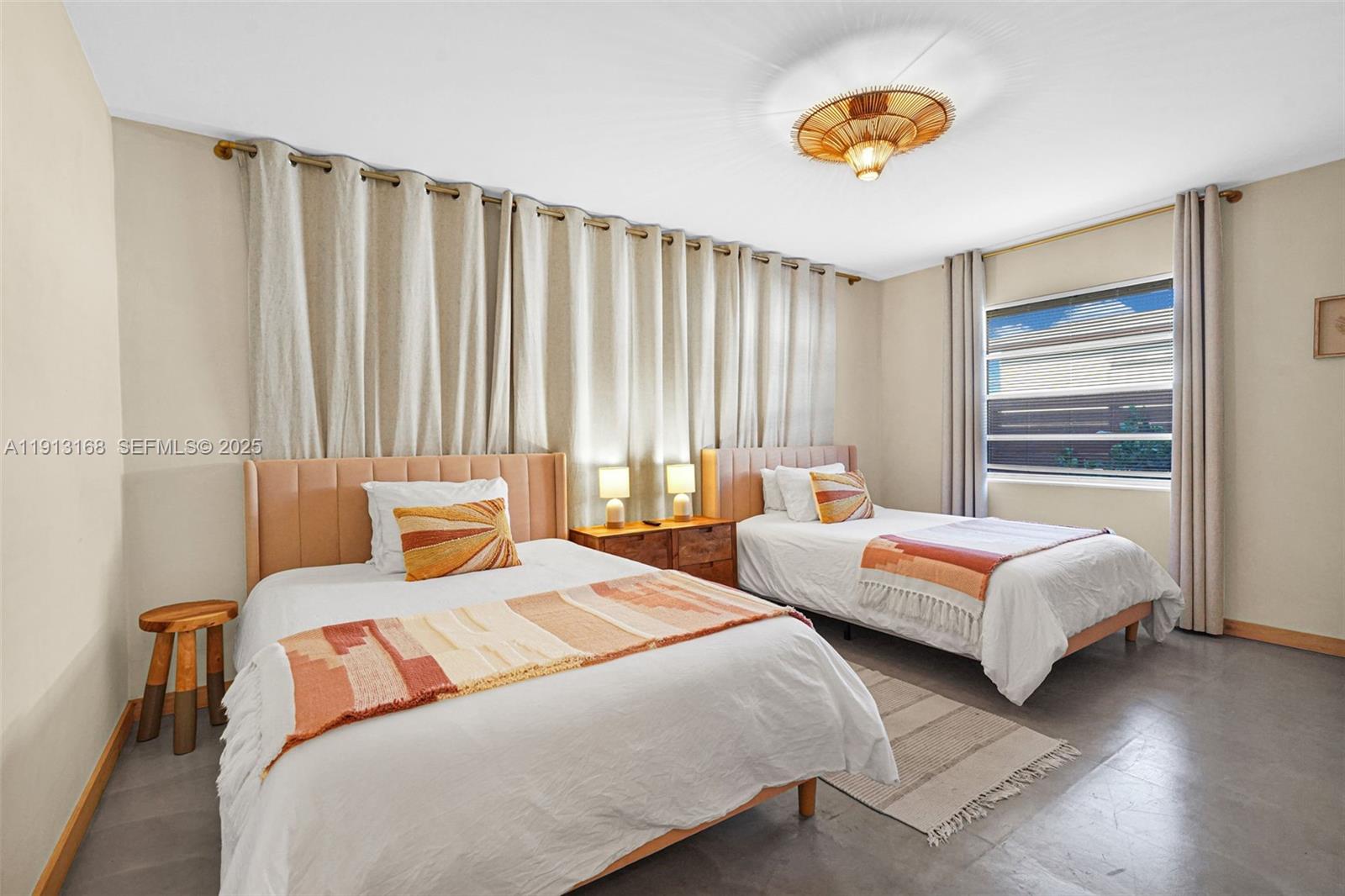 1012 Northeast 2nd Street Hallandale Beach, FL 33009 - Photo 23 of 65 a bedroom with two beds and a chandelier